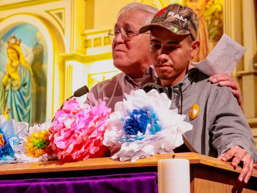 Ruben Garcia of Annunciation House introduces Wilson Alexander Juarez Hernandez at an event at Sacred Heart Church in El Paso, Texas, March 21, 2024. Hernandez was a survivor of the fire that killed 40 people and injured about two dozen more in a migration detention center in Ciudad Juarez, Mexico, in 2023. (OSV News/Courtesy of Hope Border Institute/Diego Adame)