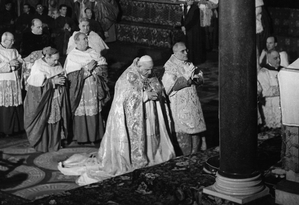 Pope John XXIII prays in the Basilica of St. Paul Outside the Walls Jan. 25, 1959, just before announcing his plans to convoke the Second Vatican Council. The pope cited a need to update the church and promote Christian unity. (CNS file photo)