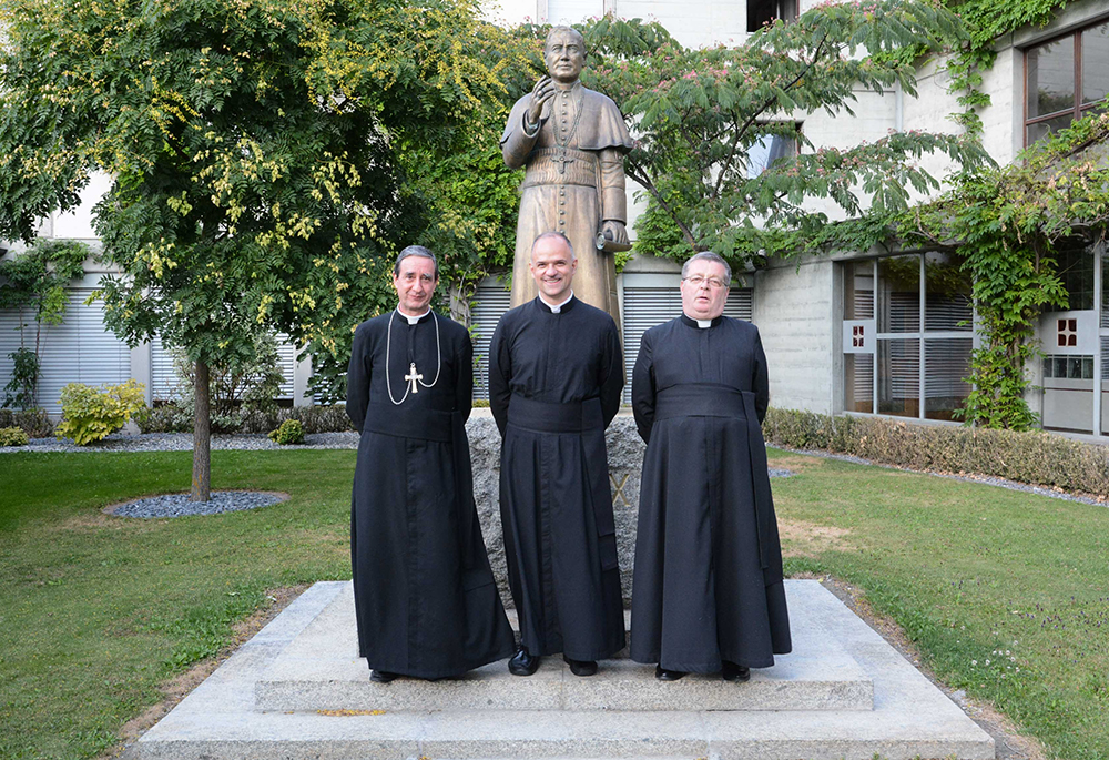 Fr. Davide Pagliarani, center, was elected July 11, 2018, as the new superior general of the traditionalist Society of St. Pius X during the society's general chapter in Econe, Switzerland. Pagliarani is pictured after his election with his assistants, Bishop Alfonso de la Galarreta, left, and Fr. Christian Bouchacourt. (CNS/Courtesy of fsspx.news)