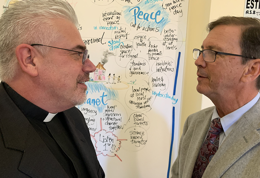 Scalabrinian Fr. Fabio Baggio, undersecretary of the Dicastery for Promoting Integral Human Development, and William Canny, executive director of the U.S. bishops' Migration and Refugee Services, talk during a break at a conference on immigration in Rome Sept. 26, 2022. The conference looked at ways to promote and support community sponsorship of refugees. (CNS/Cindy Wooden)
