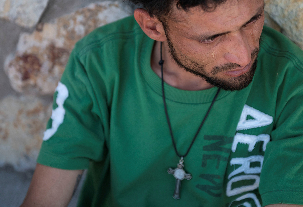 Bryan, an immigrant who says he came from Nicaragua and crossed the border to the U.S. from Mexico seeking asylum, sheds tears outside a U.S. Customs and Border Protection office near El Paso, Texas, May 9, 2023, where he was directed by U.S. border authorities as the United States prepared to lift COVID-19-era Title 42 restrictions that have blocked migrants at the U.S.-Mexico border from seeking asylum since 2020. (OSV News/Reuters/Roberto Schmidt)