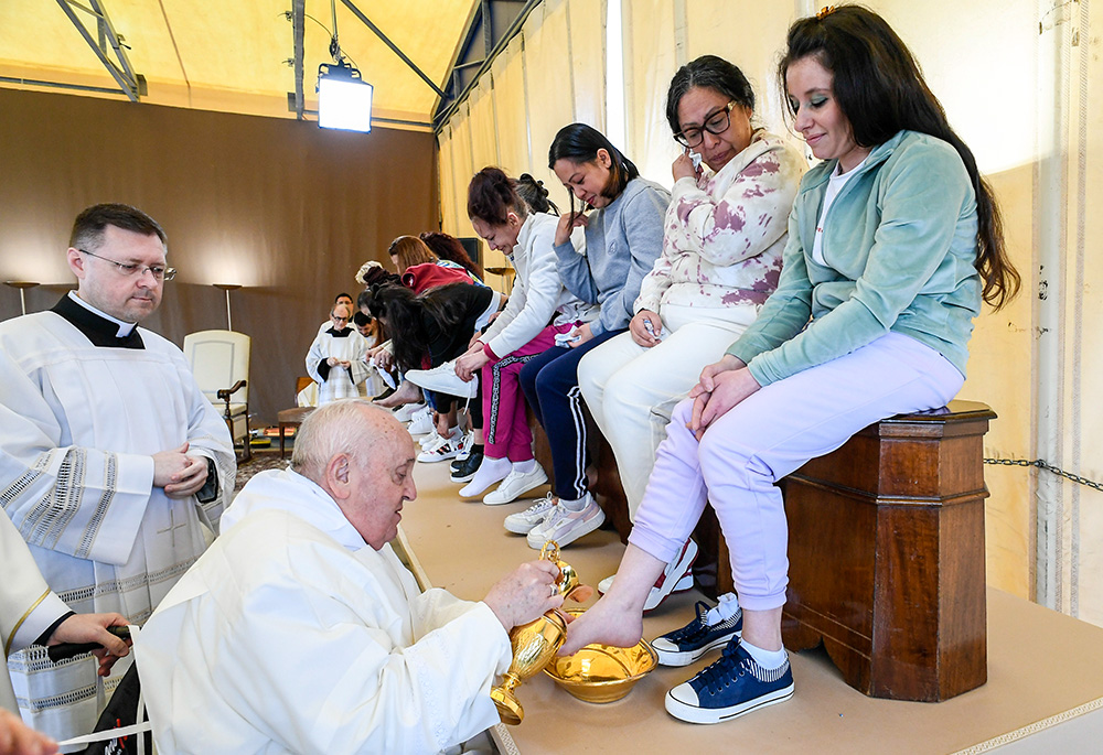 Pope Francis washes the feet of an inmate at the Rebibbia women's prison on the outskirts of Rome as he celebrates the Holy Thursday Mass of the Lord's Supper March 28, 2024. (CNS/Vatican Media)