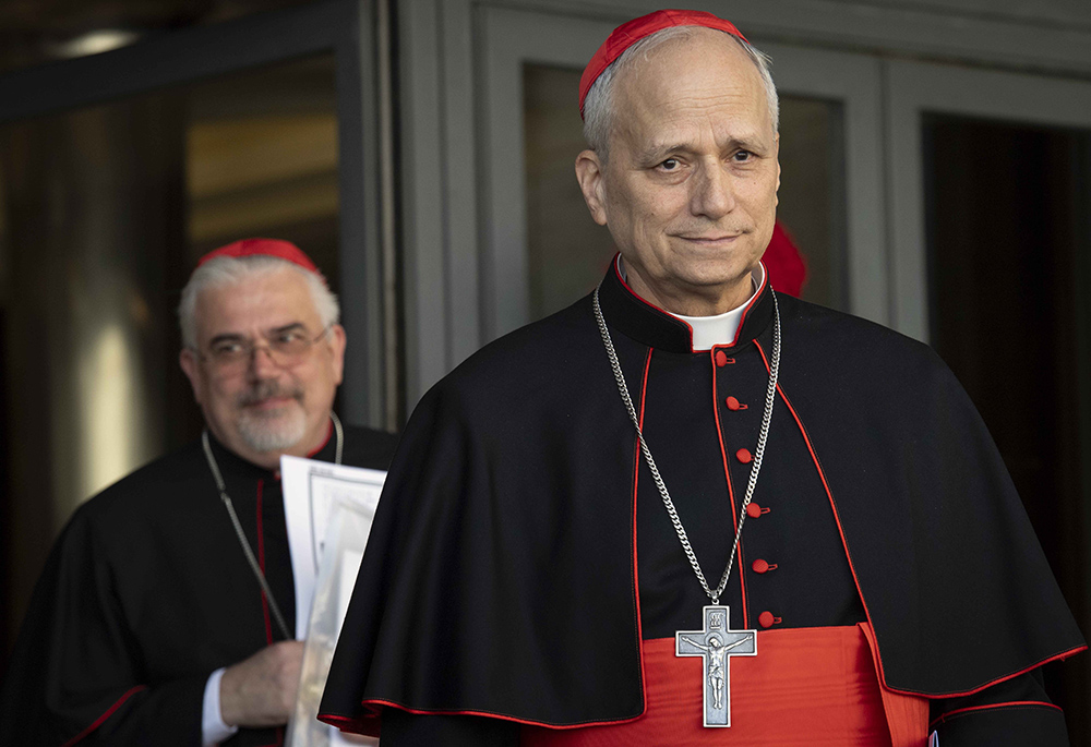 Then-Cardinal Robert F. Prevost, prefect of the Dicastery for Bishops under Pope Francis, leaves the Vatican Synod Hall April 22, 2025, after the first general congregation of the College of Cardinals. Cardinal Fabio Baggio, undersecretary of the Dicastery for Promoting Integral Human Development, walks out behind him. (CNS/Vatican Media)