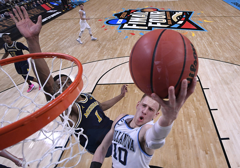 Michigan Wolverines guard Charles Matthews tries to defend a shot from Villanova Wildcats guard Donte DiVincenzo in the 2018 NCAA men's basketball championship in San Antonio. Villanova defeated Michigan, winning its second championship in three years. Villanova, Pope Leo XIV's alma mater, and the University of Notre Dame are finalizing an agreement to open the men's and women's seasons Nov. 1 in Rome. (OSV News/USA TODAY Sports via Reuters/Robert Deutsch)