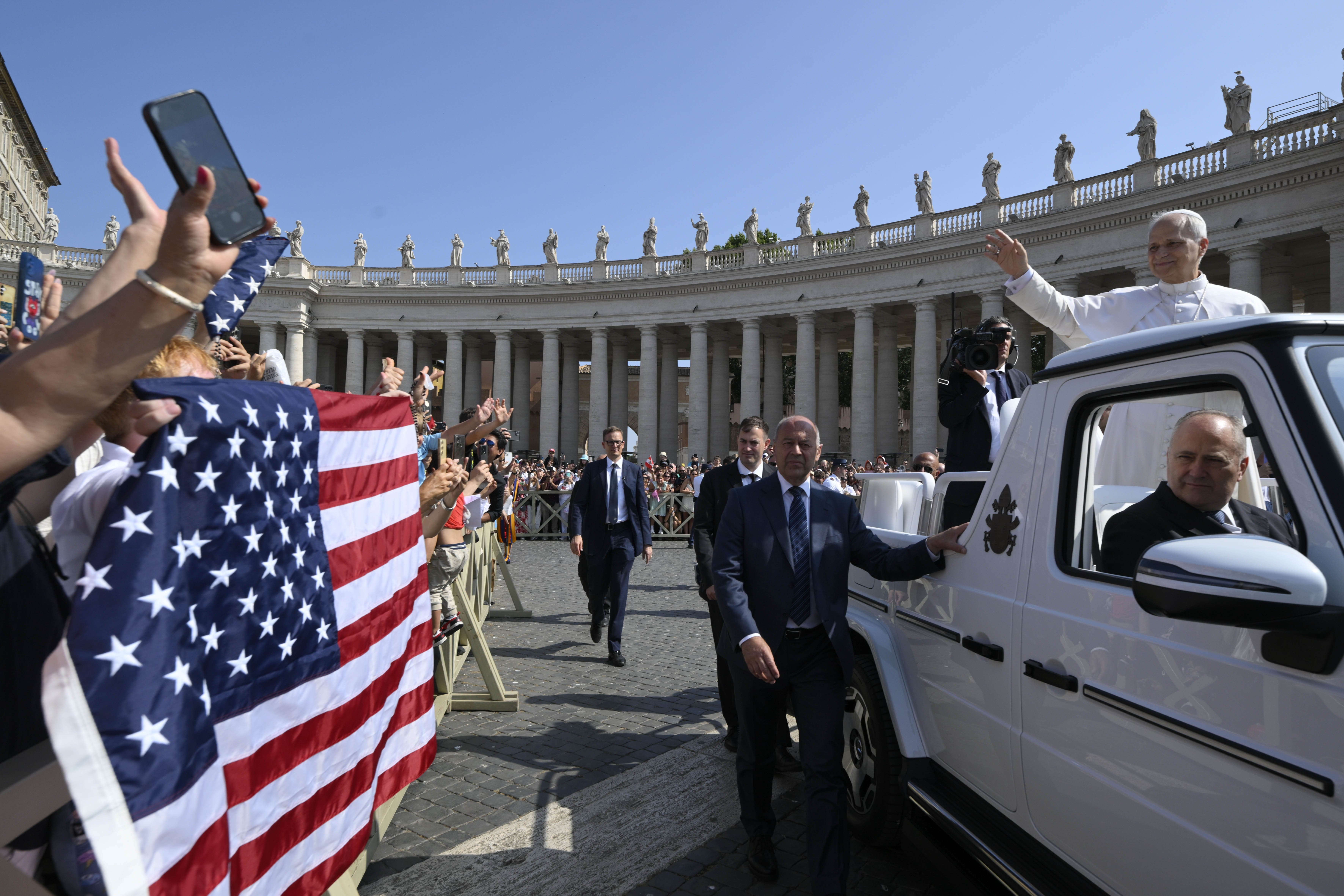 Pope Leo XIV waved to pilgrims holding a flag of the United States as he arrives in St. Peter's Square on the popemobile for his general audience at the Vatican June 18, 2025. (CNS photo/Vatican Media)