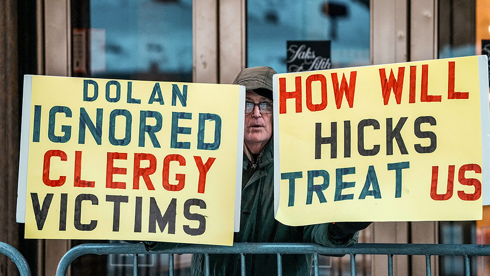 A man protests outside St. Patrick's Cathedral ahead of an evening prayer service Feb. 5, 2026, on the eve of the formal installation of Archbishop Ronald Hicks as archbishop of New York, succeeding Cardinal Timothy Dolan. (OSV News/Reuters/Eduardo Munoz)