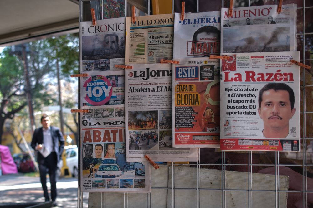 Newspapers hang on display for sale in Mexico City, Monday, Feb. 23, 2026, a day after the Mexican army killed Jalisco New Generation Cartel leader Nemesio Oseguera Cervantes, known as "El Mencho." (AP/Jon Orbach)