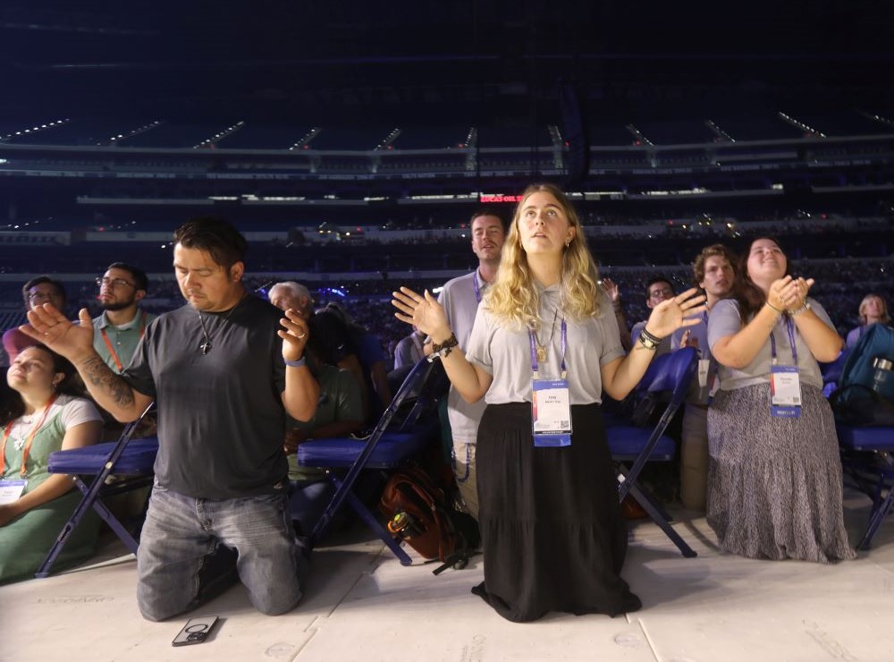 Participants pray during the opening revival night of the National Eucharistic Congress at Lucas Oil Stadium in Indianapolis July 17, 2024. The congress was the culmination of the U.S. Catholic Church's three-year National Eucharistic Revival. (OSV News/Bob Roller)