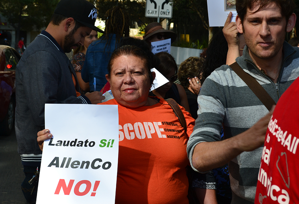 A community activist holds a sign referencing Pope Francis' encyclical Laudato Si' during a rally Oct. 4, 2017, outside the chancery of the Los Angeles Archdiocese. Residents and allies of the University Park neighborhood were urging the archdiocese to end its lease with AllenCo Energy at the oil drilling site linked to health issues in their community. California Gov. Gavin Newsom announced Feb. 11, 2026, that the site's oil wells have been permanently sealed. (Courtesy of STAND-LA)