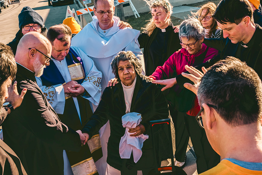 Sr. Alicia Gutierrez, a member of the congregation of the Society of Helpers, holds a chalice while being blessed by Chicago interfaith clergy outside the ICE Broadview detention center, Feb. 18, 2026. (Courtesy of Coalition for Spiritual and Public Leadership/Derek Carter)