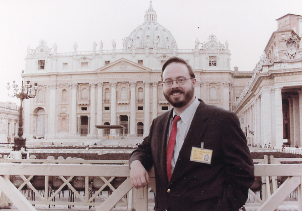 John L. Allen Jr. poses for a photo in front of St. Peter's Basilica circa 2000, when he was National Catholic Reporter's new Rome correspondent. He worked for the National Catholic Reporter 1997-2014. (NCR file photo)