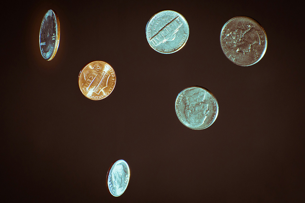 Several U.S. coins against a dark background (Unsplash/Chris Briggs)