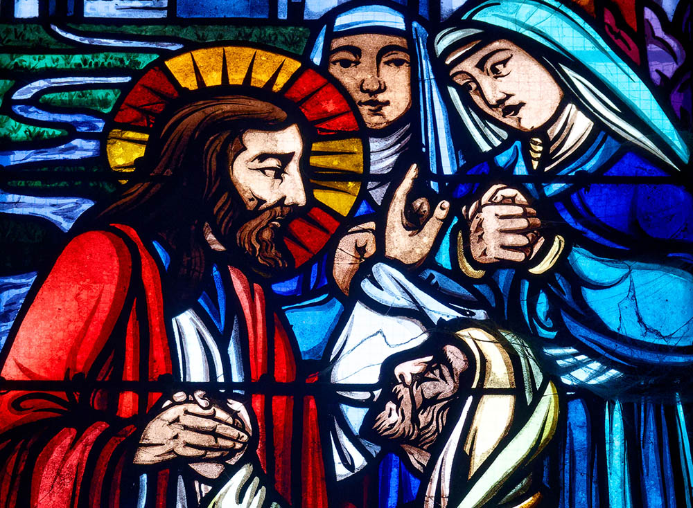 The raising of Lazarus, depicted in stained glass in a church in Orleans, France (Dreamstime/Pixelia21)