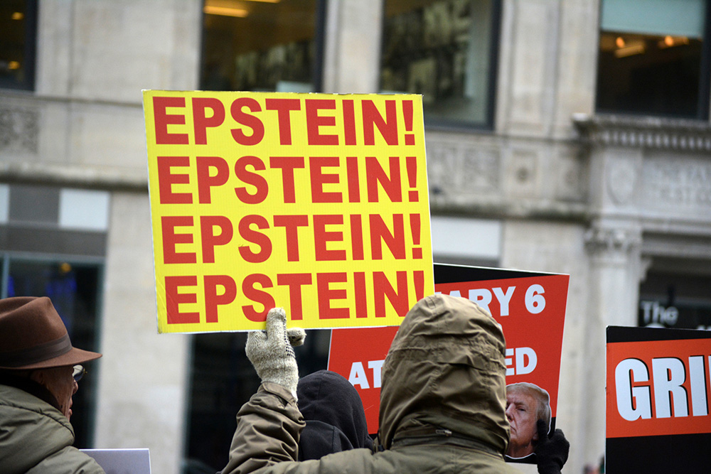 A protester holds a sign drawing attention to the Epstein files scandal during a demonstration against President Donald Trump on Jan. 6, 2026, in Manhattan, New York. (Dreamstime/Cpenler)