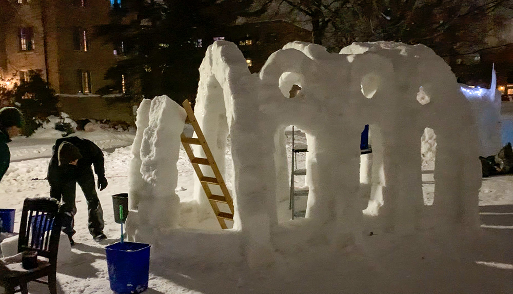 Students work on constructing St. Olaf Chapel out of ice and snow on the North Quad of the University of Notre Dame in January 2026. (Wesley Buonerba)