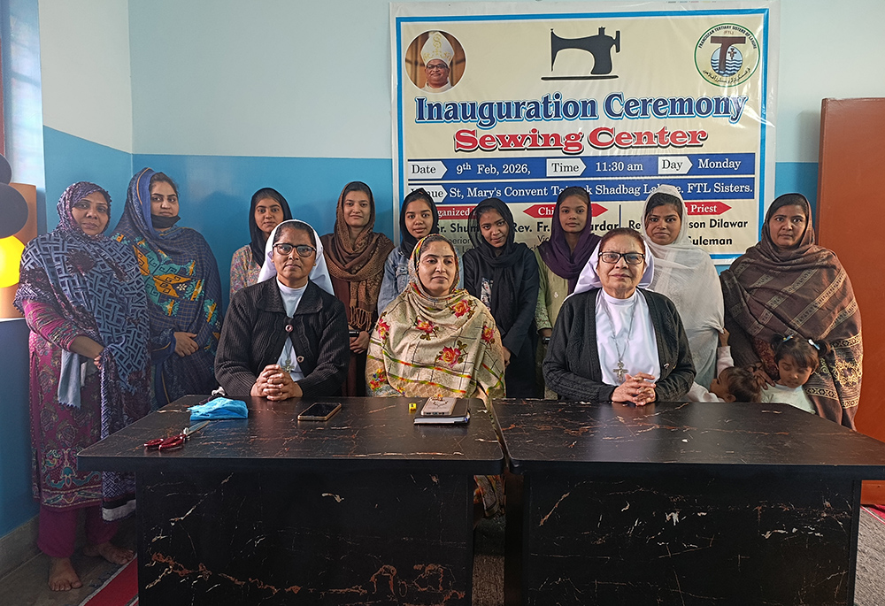 Srs. Mercy Lal, right, and Cecilia Joseph, left, pose with a group of trainees at their sewing center in Lahore, Pakistan. (Kamran Chaudry)