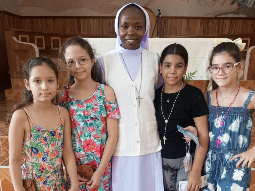 Sr. Esther Njoka, a member of the Missionary Congregation of the Evangelizing Sisters of Mary in Kenya, poses for a photo with a group of children in Puerto Padre, Cuba. She arrived in 2024 to serve a mission on the island, which in part involves catechizing young Catholics. (Courtesy of Esther Njoka)