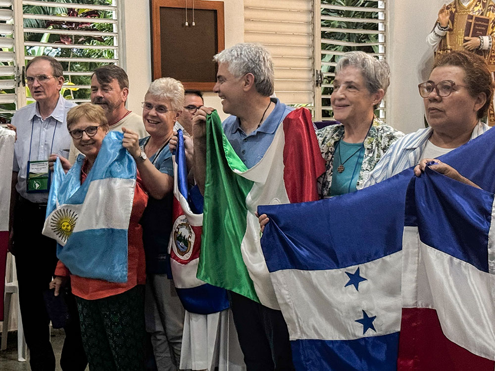Members of the Confederation of Latin American and Caribbean Religious hold flags from various Latin American countries as they sing in a chapel during a board meeting March 21, 2026, in the Dominican Republic. CLAR affirmed its commitment to the process that Pope Francis called "walking together," or synodality. (GSR photo/Rhina Guidos)