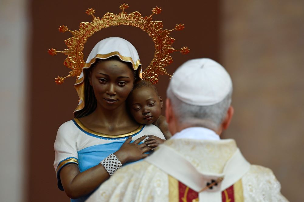 Pope Leo XIV prays in front of a statue of Mary and the Christ Child as he celebrates the final Mass of his apostolic journey to Africa at Malabo Stadium in Equatorial Guinea April 23, 2026. (OSV News/Vatican Media/Matteo Pernaselci)