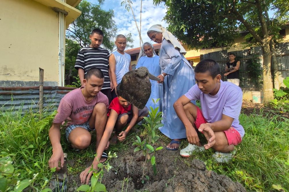 Hospitaller Sr. Merin Lukose and her superior, Sr. Juliana Mathew (left), plant a tree on the World Environment Day with young residents of Orsini Care Home at Bongaigaon, Assam state in northeastern India. (Courtesy of Merin Lukose)