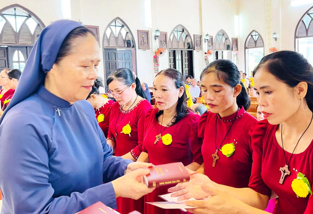 La Hna. María Madelene Le Thi Bich, de la Congregación Lovers of the Holy Cross, entrega Biblias a las nuevas integrantes del grupo de antiguas religiosas en Hue, Vietnam, el 14 de septiembre de 2025. (Foto: Joachim Pham)