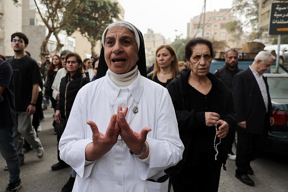 Sr. Eva Chaaya walks outside Mar Maroun Church during the Good Friday procession in the Chiyah district of Beirut's southern suburbs, Lebanon, April 3, 2026, amid escalating hostilities between Israel and Hezbollah (OSV News/Reuters/Emilie Madi)