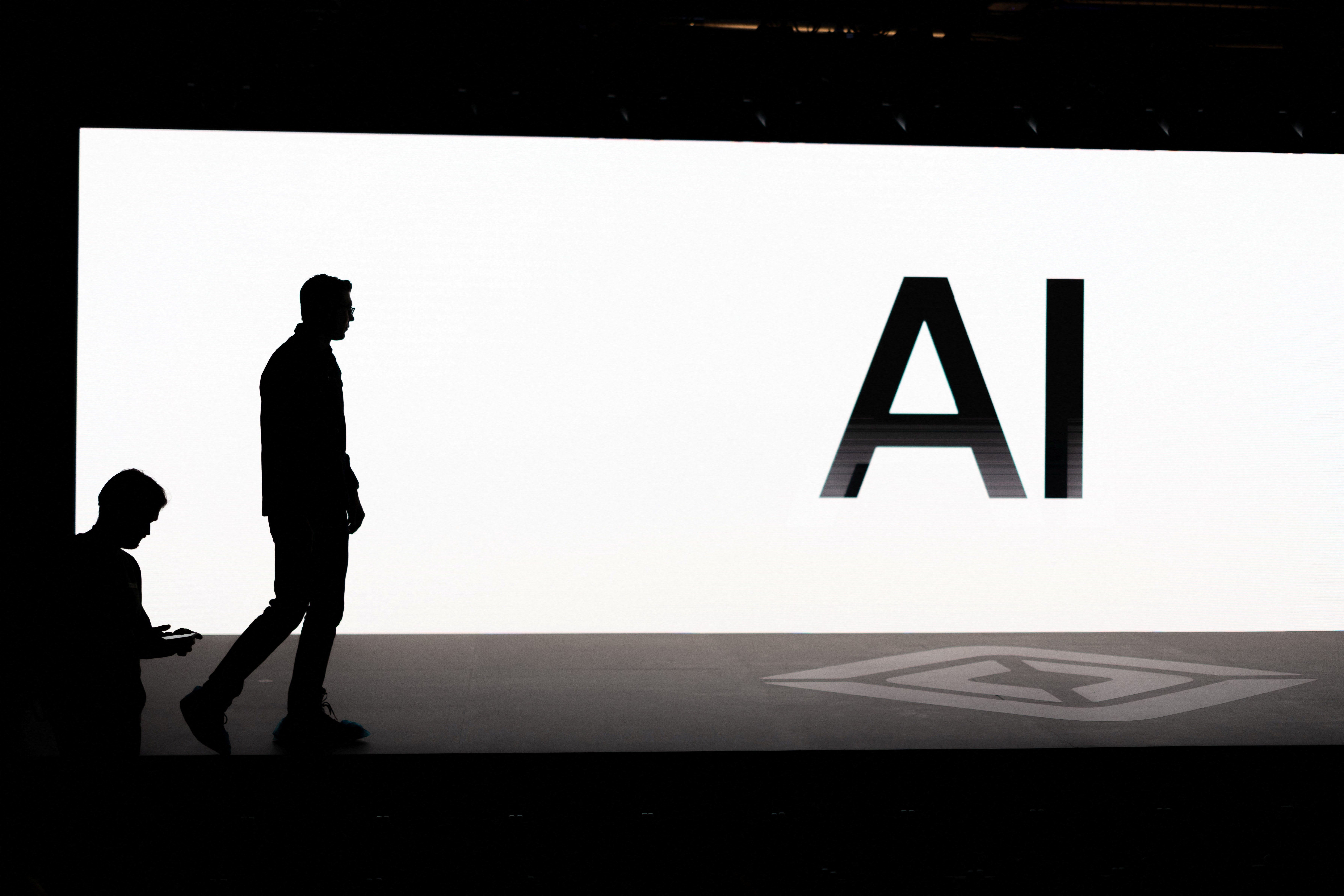 A screen reads "AI" in reference to artificial intelligence as attendees gather during Rivian's first Autonomy and AI Day in Palo Alto, Calif., 11, 2025, showcasing developments in self-driving technology. (OSV News photo/Carlos Barria, Reuters)