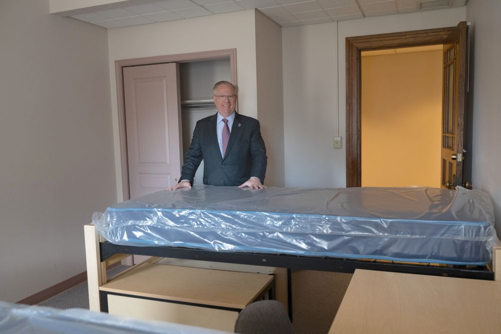 Neumann University President Chris Domes stands in a newly converted room in 2022, when university students were about to move into the Sisters of St. Francis of Philadelphia's  motherhouse for the first time. (Courtesy of Andrea Cipriani Mecchi)