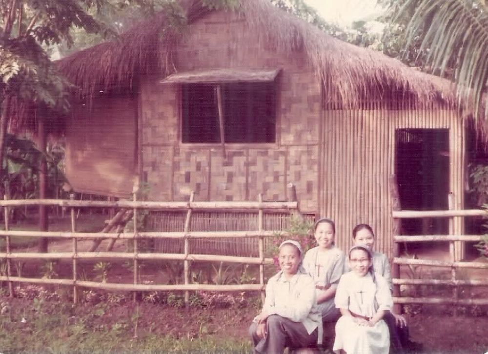 Sisters of the Little Sisters of Jesus pose outside their bamboo and nipa home, where they lived simply among workers and the poor in the 1980s. (Courtesy of Little Sisters of Jesus)