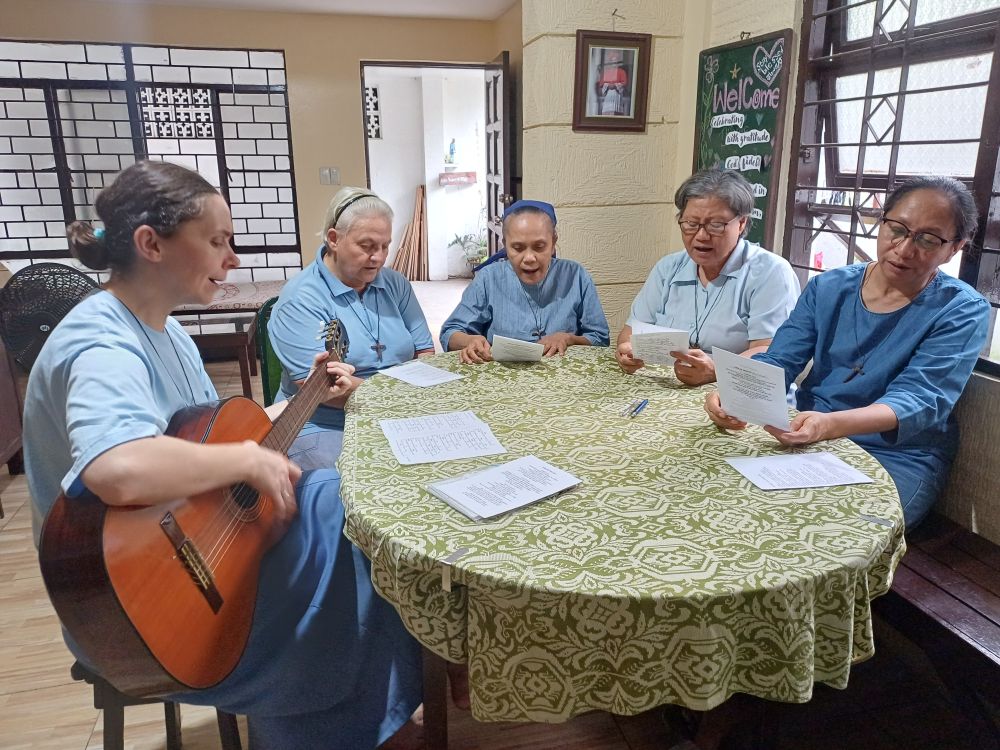 Sister Gosia plays the guitar as Sisters Annarita, Maria Elizabeth, Cecilia Grace and France Grace sing, marking 50 years of the Little Sisters of Jesus ministering in the Philippines. (Oliver Samson)