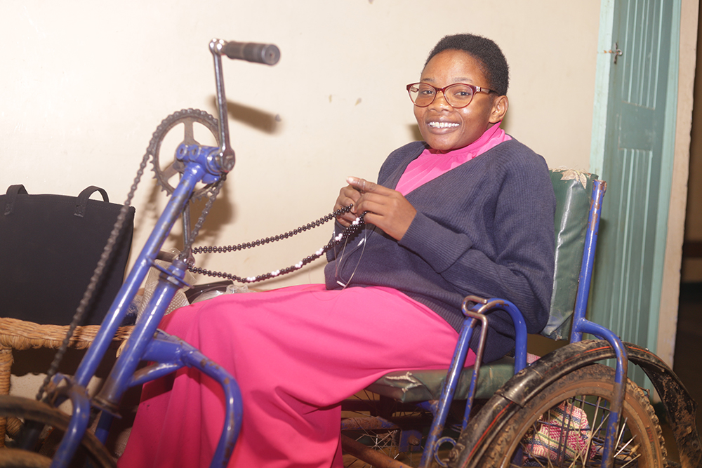 Emmaculate Omondi, born with spina bifida, sits in her wheelchair at Sigomere Small Home in Siaya County, western Kenya. She now earns income through beadwork after facing stigma and leaving mainstream school. (GSR photo/Doreen Ajiambo)