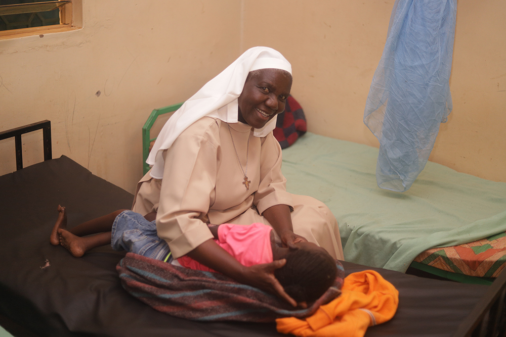 Sr. Mary Monica Amollo Owuor provides therapy support to a child at Sigomere Small Home in Siaya County, western Kenya. Many residents have living parents, but were abandoned due to poverty and stigma. (GSR photo/Doreen Ajiambo)