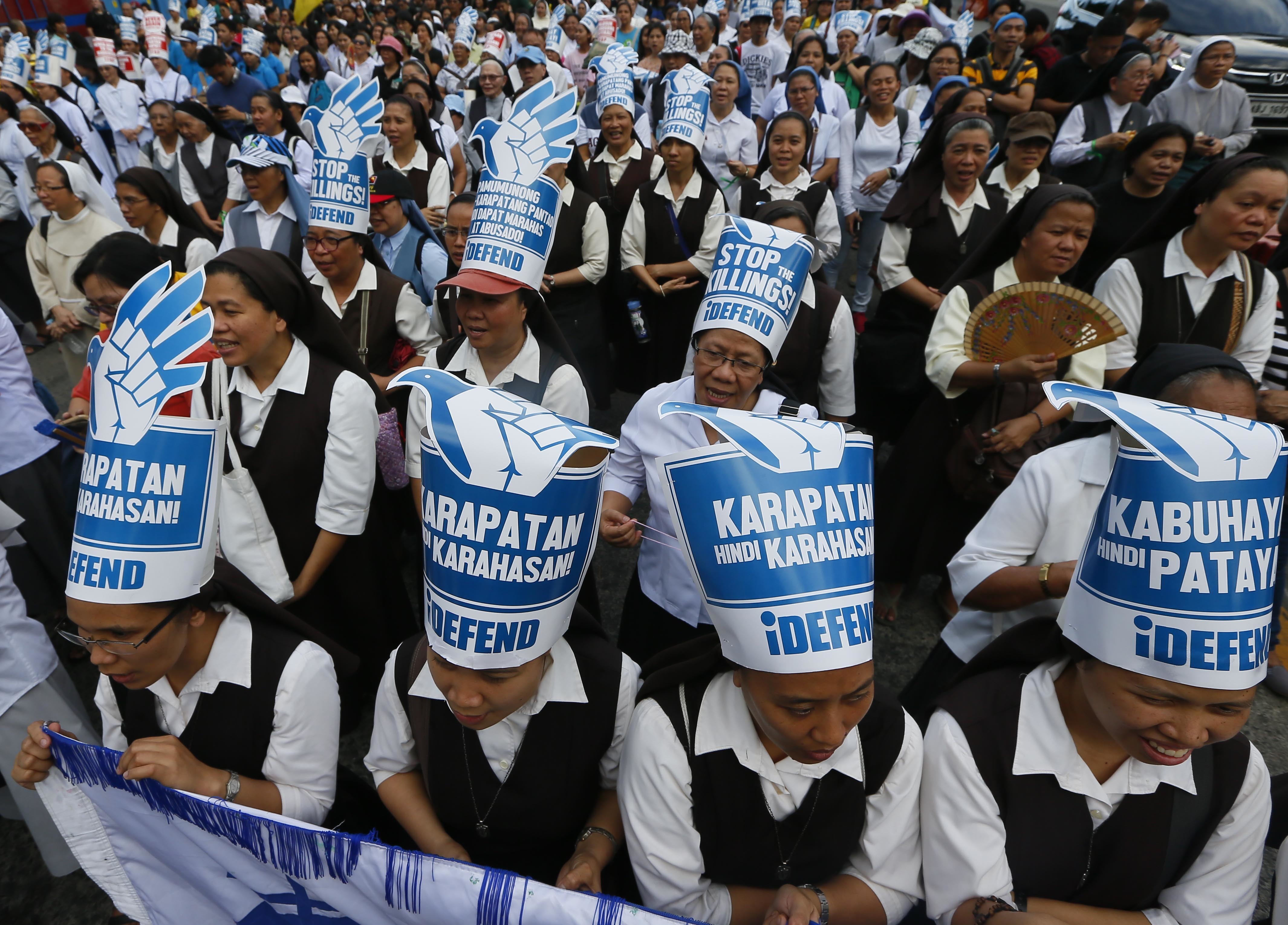 Roman Catholic nuns join hundreds of protesters as they gather at the People Power Monument to mark the 31st anniversary of the near-bloodless revolt that toppled the 20-year-rule of the late dictator Ferdinand Marcos Saturday, Feb. 25, 2017, in suburban Mandaluyong city northeast of Manila, Philippines. (AP/Bullit Marquez)