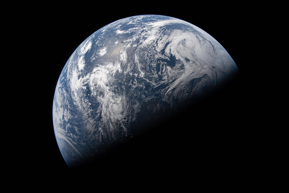 Earth is illuminated against the blackness of space in this photo taken by an Artemis II crew member through an Orion spacecraft window on April 2, 2026, the second day of the mission. (NASA)