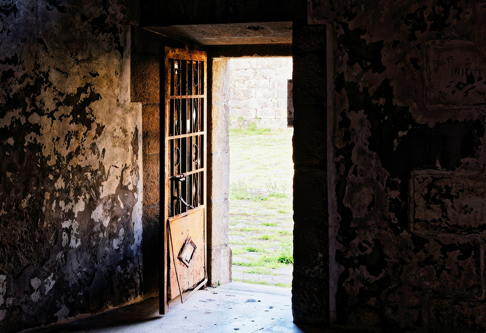 Door in a dilapidated building open to the bright outside (Unsplash/Eric Prouzet)