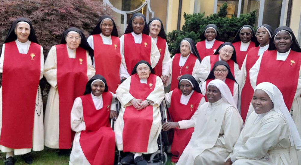 Sisters of the Monastery of the Perpetual Adorers of the Most Blessed Sacrament in Seregno, Italy, pose in a group photo, with Sr. Anna Maria of the Sacred Heart (center, front row). Perpetual adoration is at the core of their charism. (Courtesy of Perpetual Adorers of the Most Blessed Sacrament) 