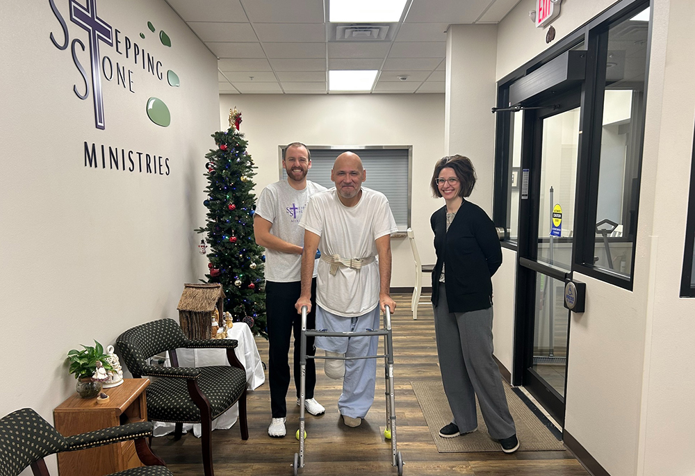 Physical therapy student Major Kelley, left, and physical therapy instructor Michelle Keller assist Stepping Stone Medical Respite resident Marlin Chase. (Courtesy of Sr. Idelle Badt)