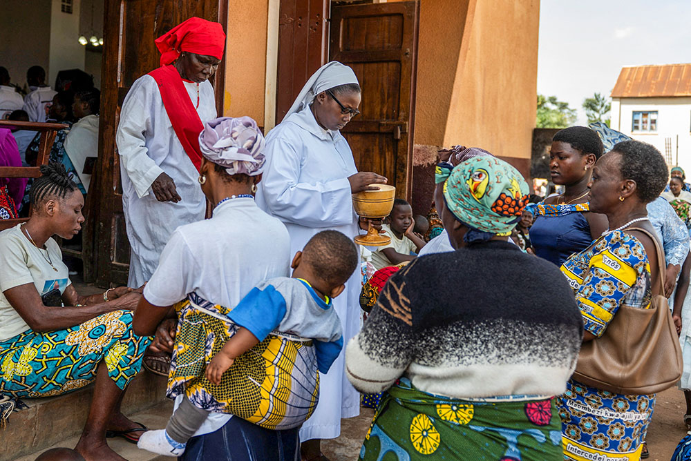 A nun distributes Communion during Mass outside the Cathedral of Our Lady of Graces in Ituri, Congo, May 24, 2026, amid a resurgence of Ebola involving the Bundibugyo strain, a rarer variant of the virus with no approved vaccine currently available. (OSV News/Reuters)
