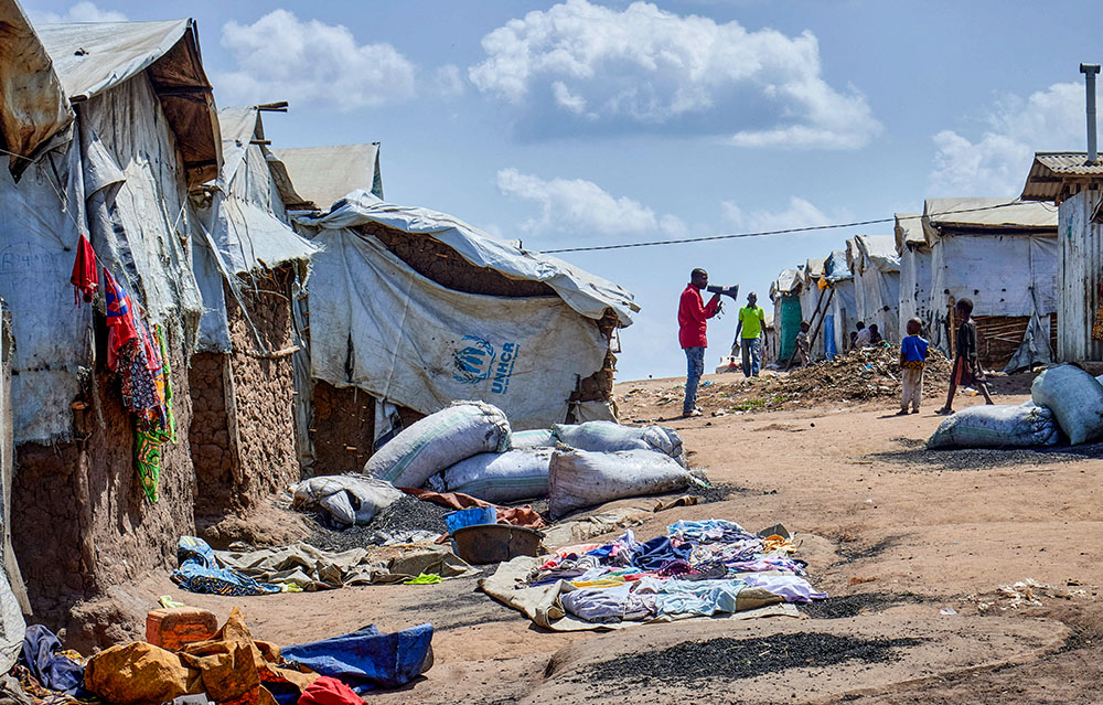 Richard Mbagaro, a supervisor at the Kigonze camp for internally displaced persons, speaks to residents in Bunia, Congo, May 25, 2026, urging them to wash their hands with soap or ash as fears grow over the spread of Ebola. (OSV news/Reuters/Gradel Muyisa Mumbere)