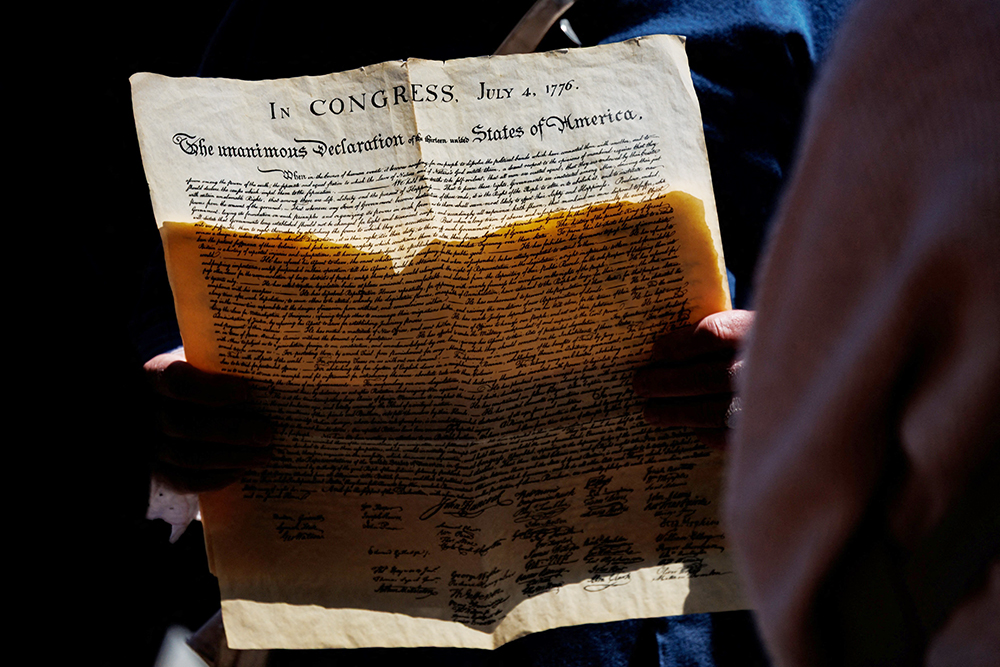 Kyle Jenks, a professional interpreter of late U.S. President James Madison, holds a copy of the Declaration of Independence while leading a tour in Philadelphia, Pennsylvania, May 1, 2026. (OSV News/Reuters/Hannah Beier)