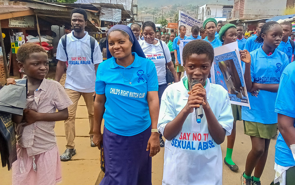 Child Rights Watch Club members and community participants join a campaign march Oct. 29, 2025, in Grafton Community, Freetown, Sierra Leone, to raise awareness on teenage pregnancy, early marriage, gender-based violence and drug abuse. (Courtesy of Misean Cara Ireland/NLW Germany)