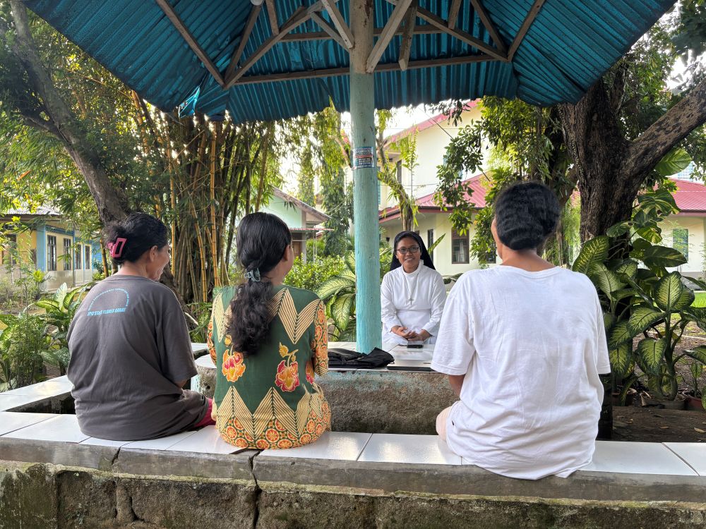 Holy Spirit Sr. Frederika Tanggu Hana speaks with female survivors of violence at St. Theresa Shelter in Labuan Bajo, eastern Indonesia. Accompaniment and trauma-informed care are central to daily ministry at the shelter, founded in 2018. (Ryan Dagur)