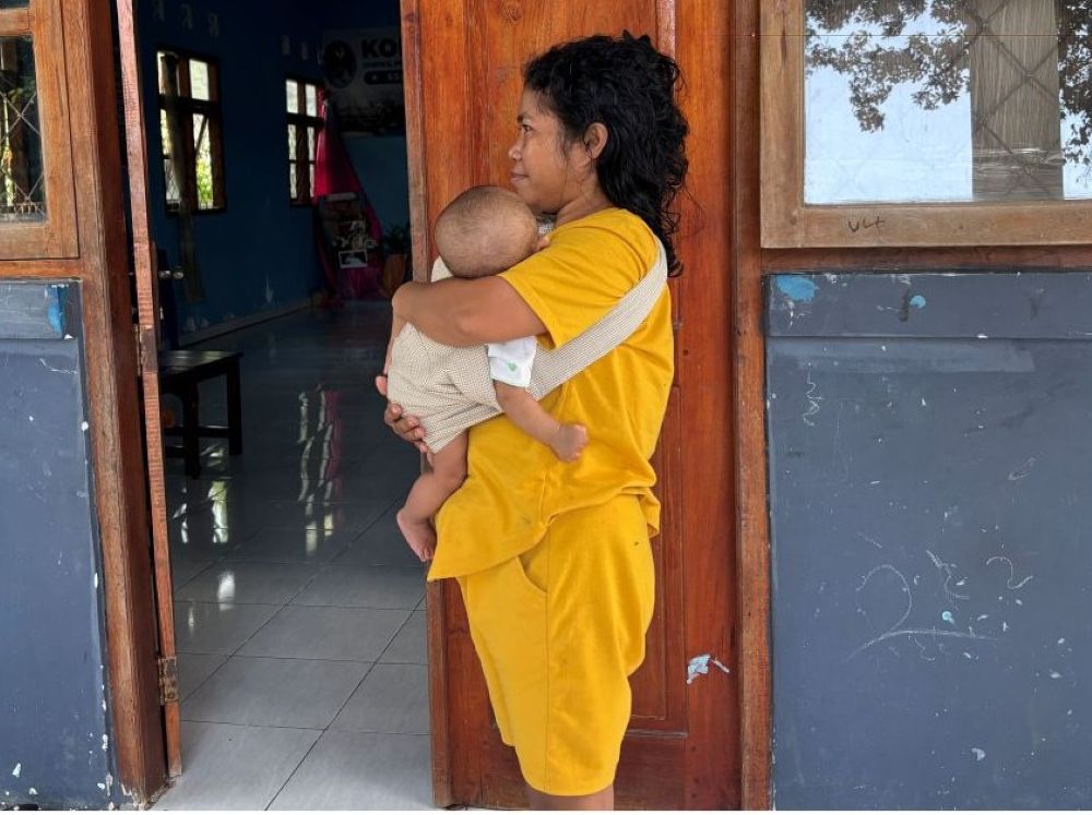 A grandmother holds her 5-month-old grandchild, born after her daughter experienced sexual violence by a close family member, at St. Theresa Shelter in Labuan Bajo, eastern Indonesia. . (Ryan Dagur)