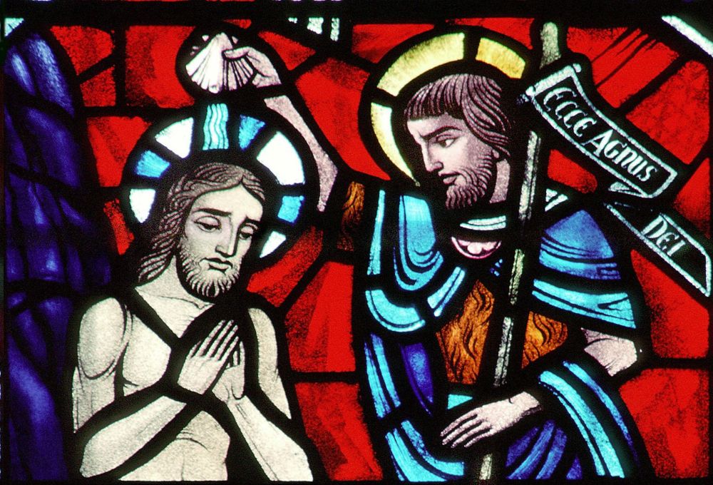 A church window depicts Christ's baptism by John the Baptist at the Jordan River. (CNS/Crosiers) 