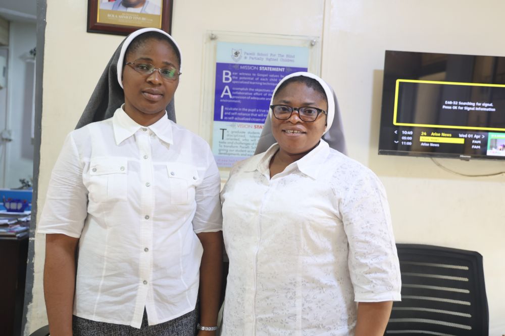 The matron of Pacelli School for the Blind and Partially Sighted Children in Lagos, Nigeria, Handmaids of the Holy Child Jesus Sr. Rosette Lirfe (left), poses for a photo with the principal, Sr. Agnes Onwudiwe. The school was founded in 1962 by the Archdiocese of Lagos. (Valentine Benjamin)