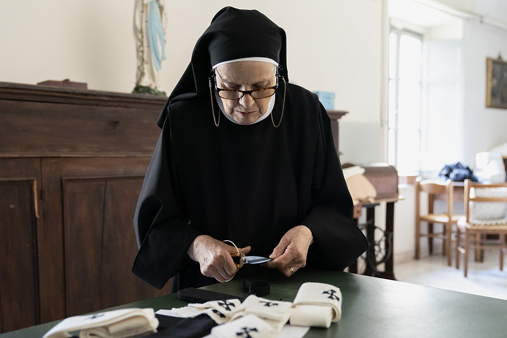 Benedictine Sr. Vincenza Portaluri prepares the pallia that will be bestowed on metropolitan archbishops in the June 29 solemnity of Sts. Peter and Paul. The vestments are made by the sisters from wool of two lambs who stay with the sisters in their Rome monastery. (Riccardo Ghilardi)