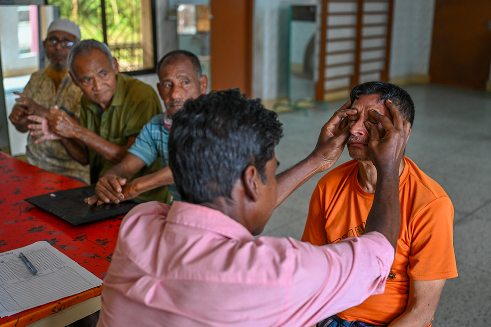 Therapist Poulinious Baskey guides a patient through exercises at the therapy center. Rehabilitation is essential for maintaining mobility in limbs affected by nerve damage. (Piyas Biswas)
