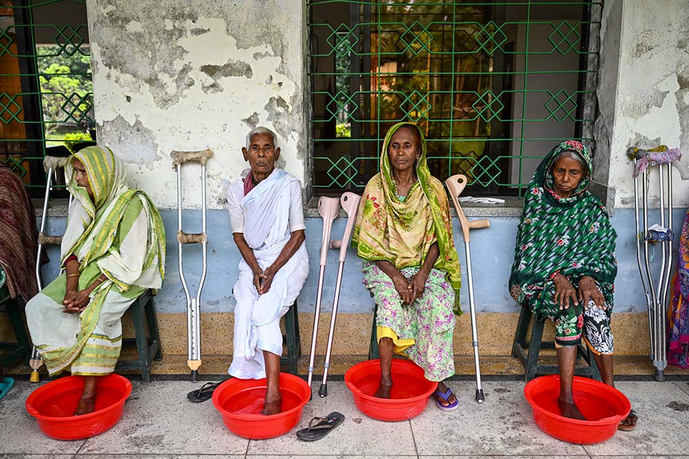 Patients soak their foot ulcers before receiving new dressings at the Dhanjuri Leprosy Center in Dinajpur, Bangladesh. Proper hygiene is a critical component of preventing secondary infections in leprosy cases. (Piyas Biswas)