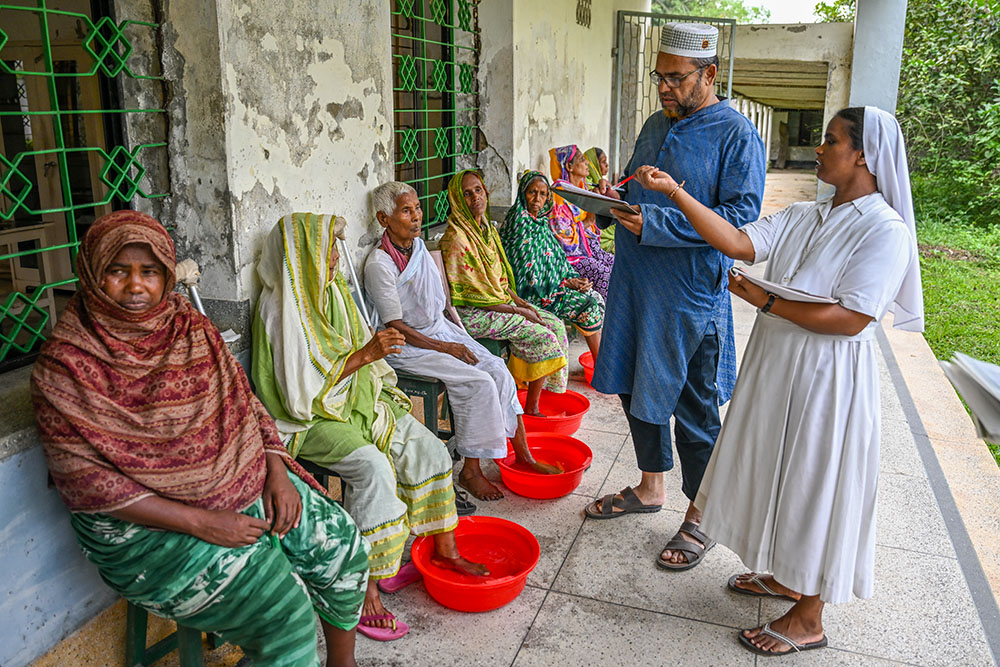 Dr. Abu Hena Mostafa Kamal examines a patient during a weekly visit at the center. Early detection is key to preventing the long-term disabilities often associated with leprosy. (Piyas Biswas)