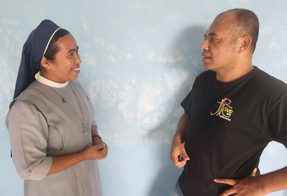 Sr. Fransiska "Ika" Imakulata, left, a Missionary Sister Servant of the Holy Spirit and coordinator of TRUK F, speaks with Divine Word Missionary Fr. Laurens Woda. (GSR/Chris Herlinger)